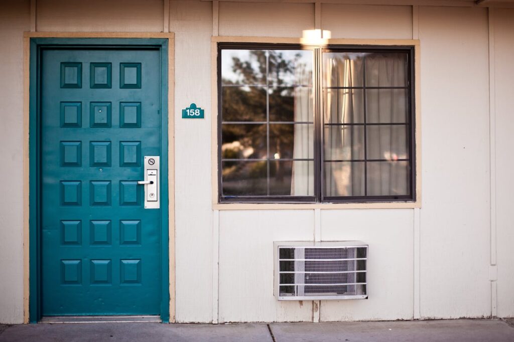 Teal Wooden Door Beside Window